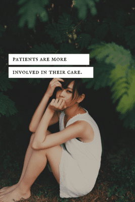 Woman sitting on the ground outside.