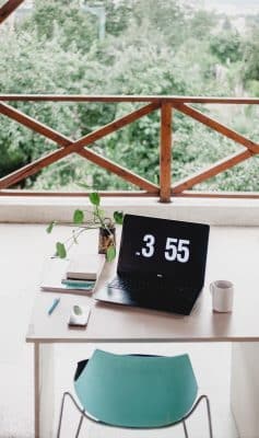 Outdoor office desk with laptop on it.