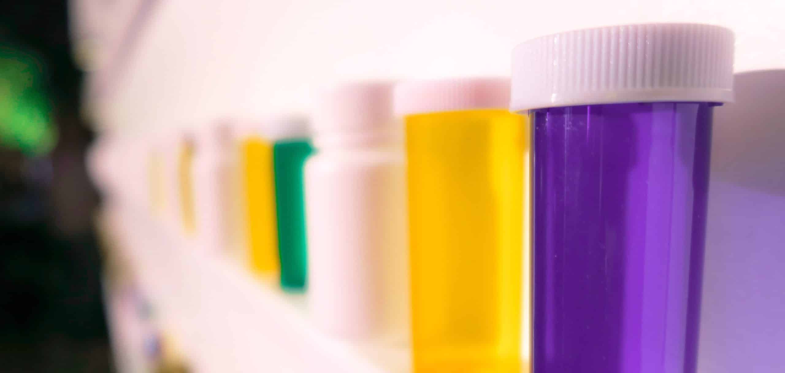 Different colored prescription bottles.