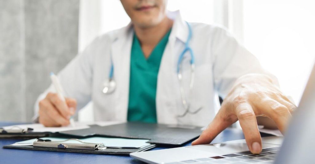 Physician on a virtual call on his laptop.