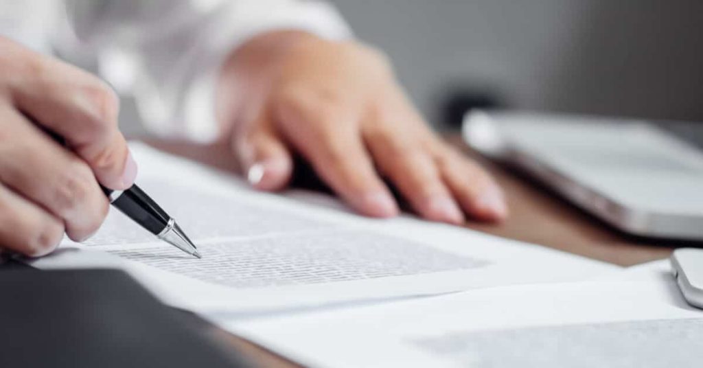 Physician signing an insurance agreement.