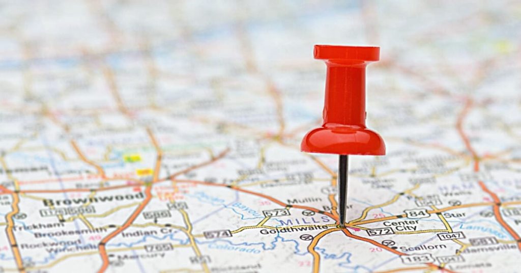Red pin nailed on a map.