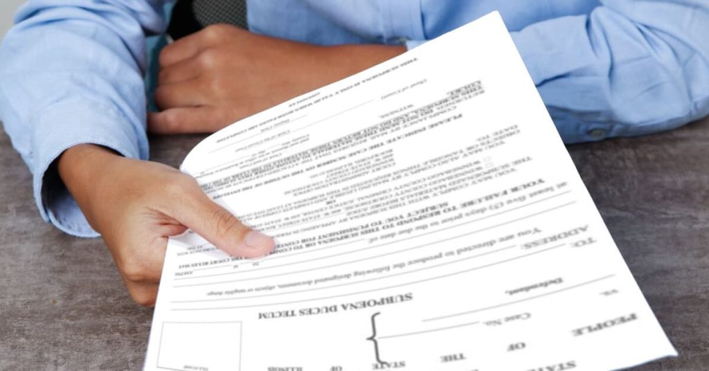 Lawyer handing over a subpoena.