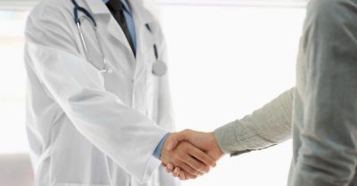 Physician shaking hands with a lawyer.