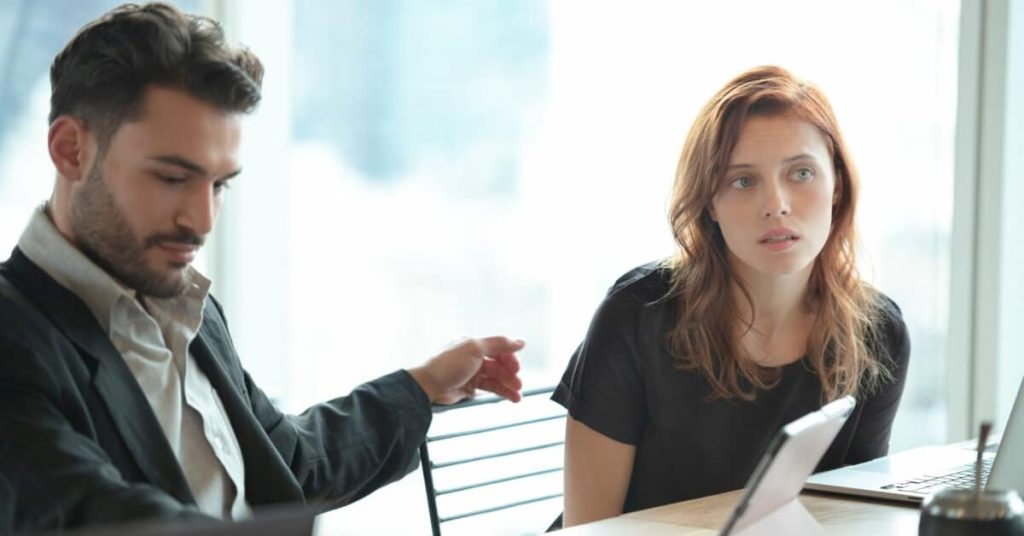 Two business colleagues working at the same table together.