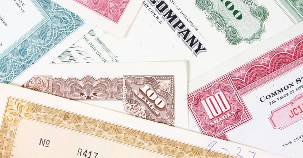 Various 100 share stock certificates.