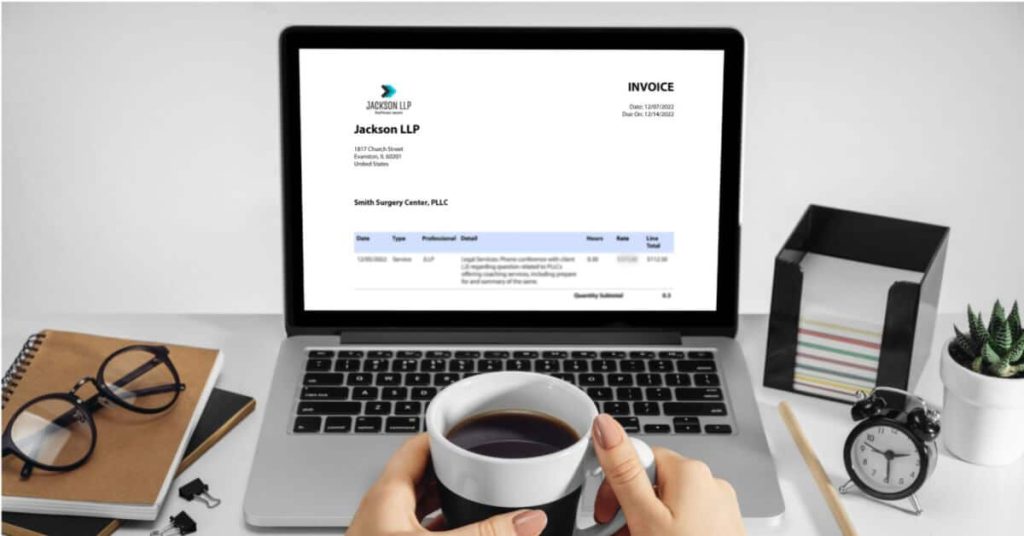 the viewer is holding a cup of coffee looking at a laptop screen displaying a Jackson LLP invoice