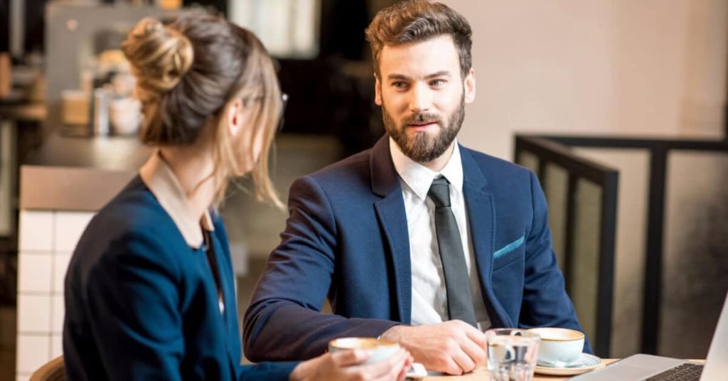 A woman and a man discussing business