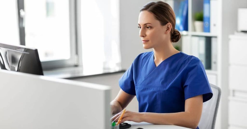 Female healthcare professional using a computer