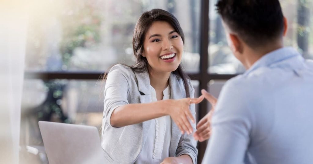 Hiring manager shaking the hand of an interview candidate.