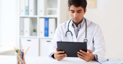 Physician looking at a laptop