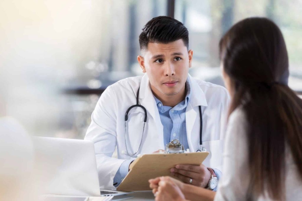 A physician speaking to a patient.