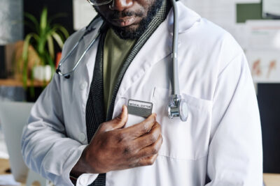 Physician wearing a Medical Doctor name badge, illustrating disclosure rules for non-physicians using the Dr. title.