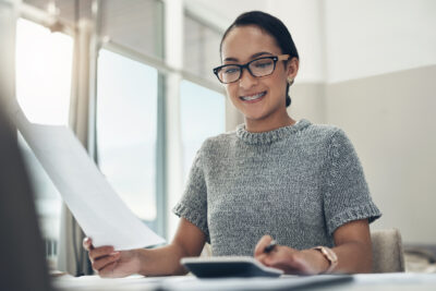 A therapist reviews financial documents to determine if cash-pay or insurance-based therapy practice is best.