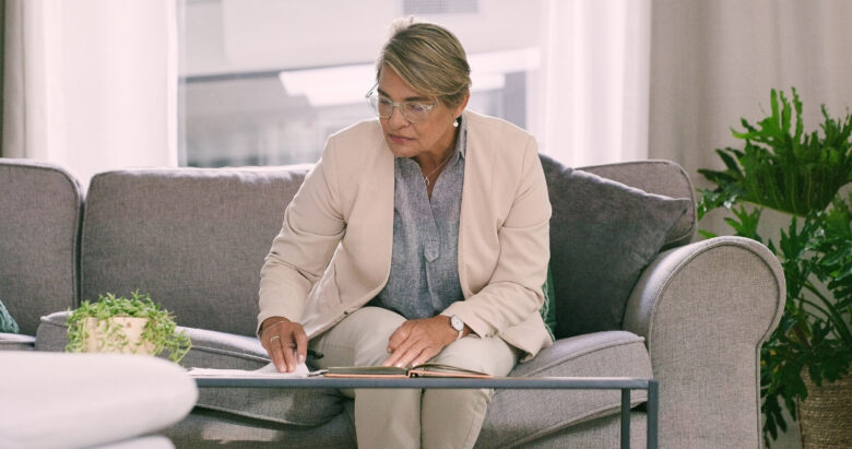 Illinois mental health provider reviewing self-assembled DIY patient intake forms while seated on a couch.