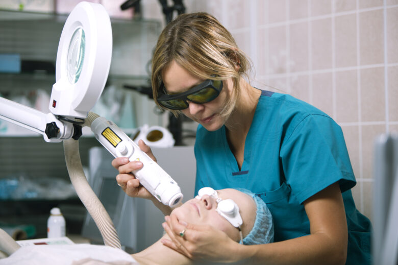 Illinois provider in scrubs performing a laser hair removal