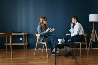Mental health supervisor meeting with a supervisee during a clinical supervision session.