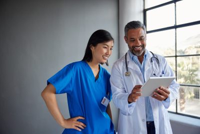 Male physician discussing collaborative practice information with a nurse practitioner.