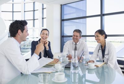 Doctors meeting with legal professionals to start a medical practice.