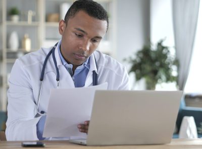 A male doctor reviewing a contract in his office